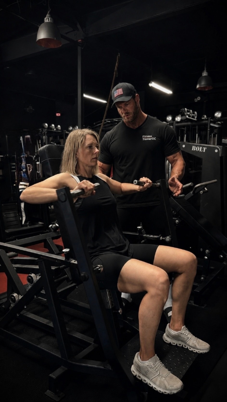 Personal trainer coaching client in premium gym